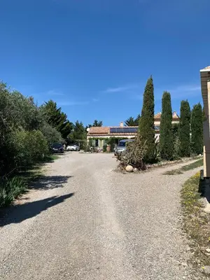 an empty road with a building in the background at LA LAVANDIERE Famille Amis Relais Motards in Peyriac-de-Mer