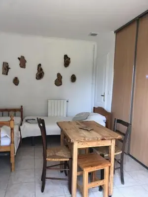 a room with a table and a room with a bed at LA LAVANDIERE Famille Amis Relais Motards in Peyriac-de-Mer