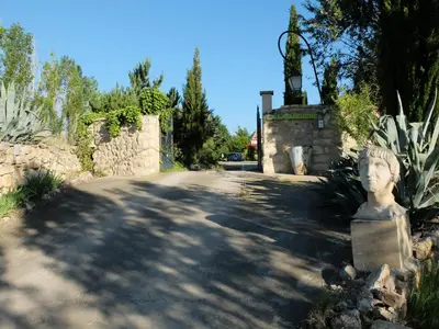 a road with a statue in the middle of a street at Gite LA FONTAINE Famille Amis Relais Motards in Peyriac-de-Mer