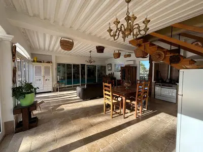 a kitchen with a table and chairs in a room at Gite LA FONTAINE Famille Amis Relais Motards in Peyriac-de-Mer