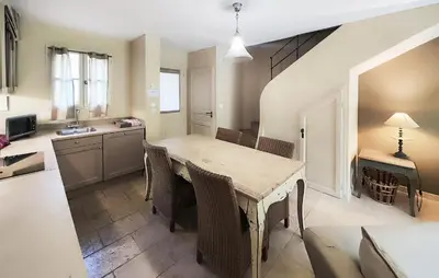 a kitchen and dining room with a table and chairs at Lovely Home In Saint-Laurent-De-La-Ca in Saint-Laurent-de-la-Cabrerisse
