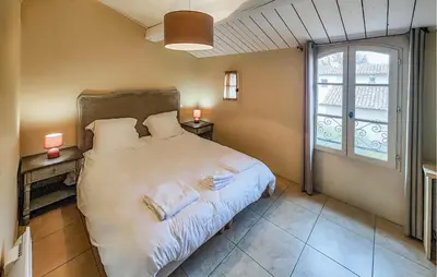 a bedroom with a large bed and a window at 2 Bedroom Stunning Home In Saint-Laurent-De-La-Ca in Saint-Laurent-de-la-Cabrerisse