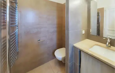 a bathroom with a toilet and a sink and a shower at Cozy Home In Saint-Laurent-De-La-Ca With Wifi in Saint-Laurent-de-la-Cabrerisse