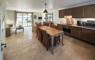 a kitchen and dining room with a table and chairs at Cozy Home In Saint-Laurent-De-La-Ca With Wifi in Saint-Laurent-de-la-Cabrerisse