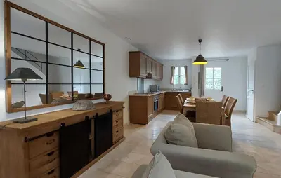 a kitchen and living room with a couch and a table at Cozy Home In Saint-Laurent-De-La-Ca With Wifi in Saint-Laurent-de-la-Cabrerisse