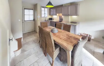 a kitchen with a wooden table and some chairs at Lovely Home In Stlaurent-De-La-Cabr in Saint-Laurent-de-la-Cabrerisse