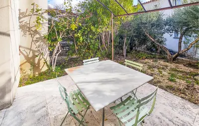 a white table and chairs on a patio at Lovely Home In Stlaurent-De-La-Cabr in Saint-Laurent-de-la-Cabrerisse