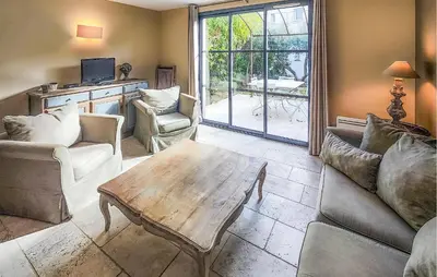 a living room with couches and a coffee table at Lovely Home In Stlaurent-De-La-Cabr in Saint-Laurent-de-la-Cabrerisse