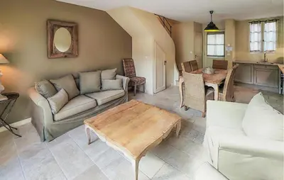 a living room with a couch and a table at Lovely Home In Stlaurent-De-La-Cabr in Saint-Laurent-de-la-Cabrerisse
