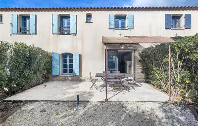 a house with a table and chairs in front of it at Amazing Home In Saint-Laurent-De-La-Ca With Wifi in Saint-Laurent-de-la-Cabrerisse