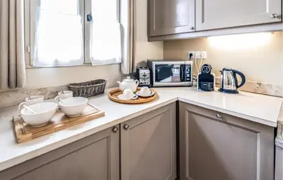a kitchen counter with bowls and a microwave at Amazing Home In Saint-Laurent-De-La-Ca With Wifi in Saint-Laurent-de-la-Cabrerisse
