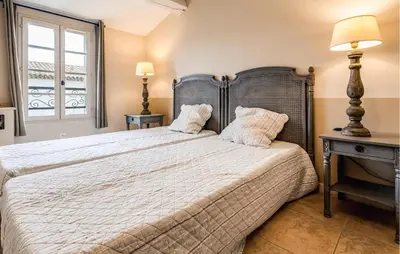 a bedroom with a large bed and a window at Amazing Home In Saint-Laurent-De-La-Ca With Wifi in Saint-Laurent-de-la-Cabrerisse