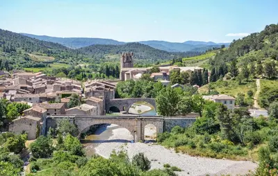 a small town with a bridge and a river at Amazing Home In Saint-Laurent-De-La-Ca With Wifi in Saint-Laurent-de-la-Cabrerisse