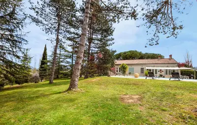 a yard with a tree and a house at 2 Bedroom Cozy Home In Tabre in Tabre
