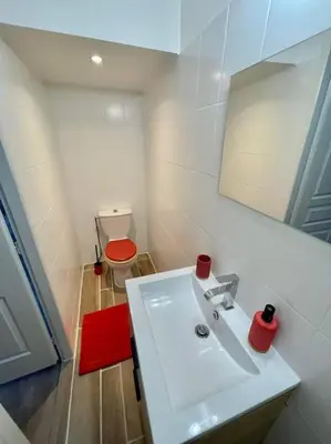 a bathroom with a white sink and a red toilet at * Maison chez J&J - Cité médiévale * in Carcassonne