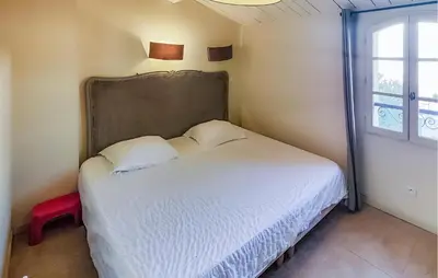 a bedroom with a white bed with a large window at Pet Friendly Home In Saint-Laurent-De-La-Ca in Saint-Laurent-de-la-Cabrerisse