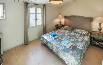 a bedroom with a bed with two towels on it at Pet Friendly Home In Saint-Laurent-De-La-Ca in Saint-Laurent-de-la-Cabrerisse