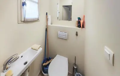 a bathroom with a white toilet and a sink at Pet Friendly Home In Saint-Laurent-De-La-Ca in Saint-Laurent-de-la-Cabrerisse