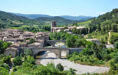 a small village with a bridge and a river at Pet Friendly Home In Saint-Laurent-De-La-Ca in Saint-Laurent-de-la-Cabrerisse