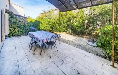 a table and chairs sitting on a patio at 2 Bedroom Lovely Home In Saint-Laurent-De-La-Ca in Saint-Laurent-de-la-Cabrerisse