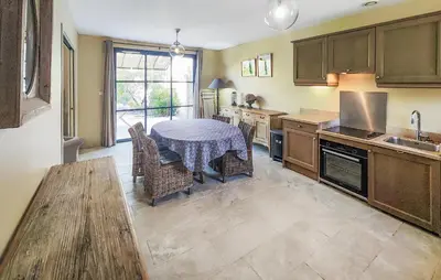 a kitchen with a table with a table cloth on it at 2 Bedroom Lovely Home In Saint-Laurent-De-La-Ca in Saint-Laurent-de-la-Cabrerisse
