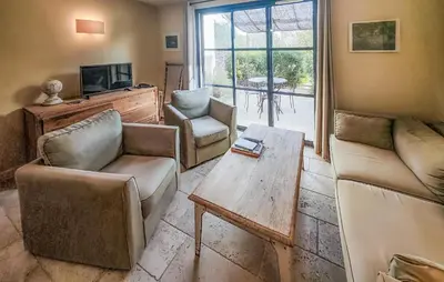 a living room with a couch and chairs and a table at Nice Home In Saint-Laurent-De-La-Ca in Saint-Laurent-de-la-Cabrerisse
