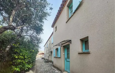 an alley between two buildings with blue doors at Nice Home In Saint-Laurent-De-La-Ca in Saint-Laurent-de-la-Cabrerisse