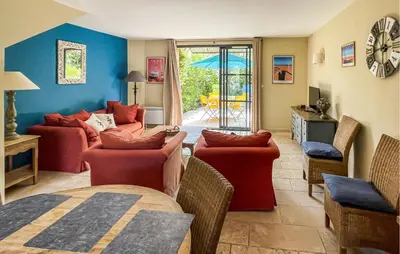 a living room with couches and chairs and a table at Nice Home In Stlaurent-De-La-Cabr With Wifi in Saint-Laurent-de-la-Cabrerisse