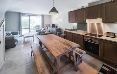 a kitchen with a wooden table in a room at 2 Bedroom Amazing Home In Stlaurent-De-La-Cabr in Saint-Laurent-de-la-Cabrerisse