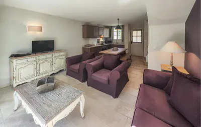 a living room with two couches and a table at 2 Bedroom Lovely Home In St-Laurent-De-La-Carbr in Saint-Laurent-de-la-Cabrerisse