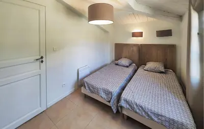 a small bedroom with a bed and a closet at 2 Bedroom Lovely Home In St-Laurent-De-La-Carbr in Saint-Laurent-de-la-Cabrerisse