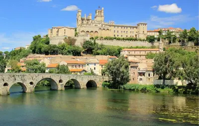 a bridge over a river with a castle in the background at 2 Bedroom Lovely Home In St-Laurent-De-La-Carbr in Saint-Laurent-de-la-Cabrerisse