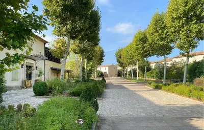 a cobblestone street in a garden with trees at 2 Bedroom Lovely Home In St-Laurent-De-La-Carbr in Saint-Laurent-de-la-Cabrerisse