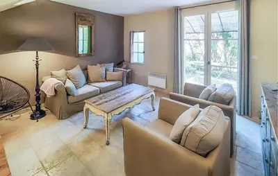 a living room with couches and a table at Nice Home In Saint-Laurent-De-La-Ca in Saint-Laurent-de-la-Cabrerisse