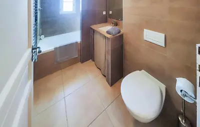 a bathroom with a toilet and a sink at Nice Home In Saint-Laurent-De-La-Ca in Saint-Laurent-de-la-Cabrerisse