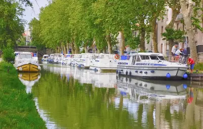a group of boats are docked in a canal at Nice Home In Saint-Laurent-De-La-Ca in Saint-Laurent-de-la-Cabrerisse