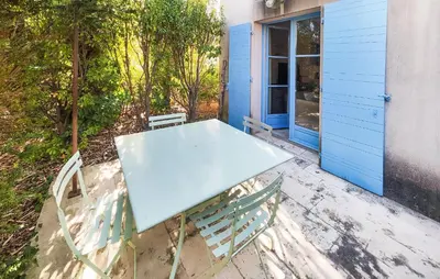 a blue table and chairs sitting on a patio at Nice Home In Saint-Laurent-De-La-Ca in Saint-Laurent-de-la-Cabrerisse