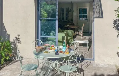 a table and chairs sitting on a patio at 2 Bedroom Cozy Home In Saint-Laurent-De-La-Ca in Saint-Laurent-de-la-Cabrerisse