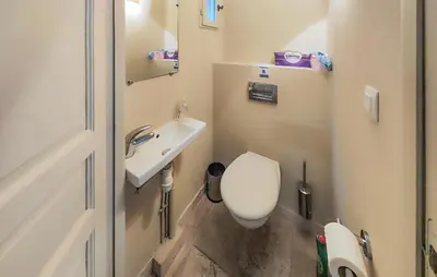 a small bathroom with a toilet and a sink at 2 Bedroom Cozy Home In Saint-Laurent-De-La-Ca in Saint-Laurent-de-la-Cabrerisse