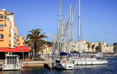 a group of boats docked in a marina with buildings at 2 Bedroom Cozy Home In Saint-Laurent-De-La-Ca in Saint-Laurent-de-la-Cabrerisse