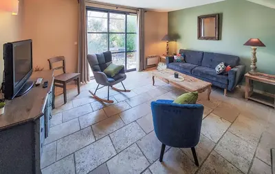 a living room with a couch and a tv at Lovely Home In Saint-Laurent-De-La-Ca in Saint-Laurent-de-la-Cabrerisse