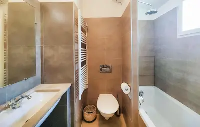 a bathroom with a tub and a toilet and a sink at Lovely Home In Saint-Laurent-De-La-Ca in Saint-Laurent-de-la-Cabrerisse