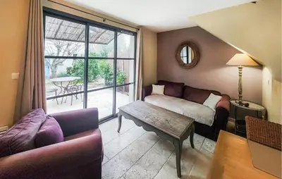 a living room with a couch and a table at 1 Bedroom Awesome Home In Saint-Laurent-De-La-Ca in Saint-Laurent-de-la-Cabrerisse