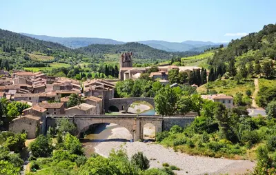 a small village with a bridge and a river at 1 Bedroom Awesome Home In Saint-Laurent-De-La-Ca in Saint-Laurent-de-la-Cabrerisse