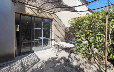 a bench sitting on a patio next to a building at Nice Home In Saint-Laurent-De-La-Ca With Wifi in Saint-Laurent-de-la-Cabrerisse