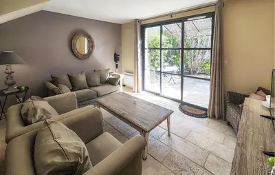 a living room with a couch and a table at Nice Home In Saint-Laurent-De-La-Ca With Wifi in Saint-Laurent-de-la-Cabrerisse