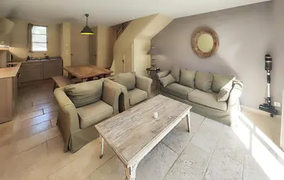 a living room with two couches and a table at Nice Home In Saint-Laurent-De-La-Ca With Wifi in Saint-Laurent-de-la-Cabrerisse
