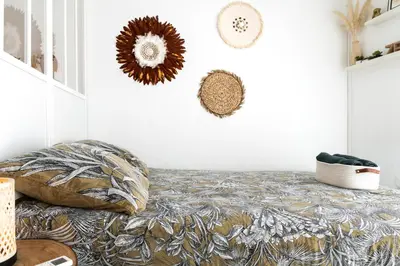a living room with a bed and a table at Le Boho Chic Studio Cosy in Narbonne