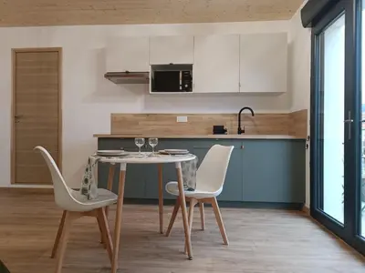 a kitchen with a table and two chairs at Studio dans le Minervois in Bize-Minervois