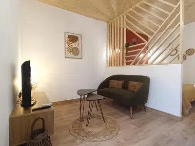a living room with a couch and a chair at Studio dans le Minervois in Bize-Minervois